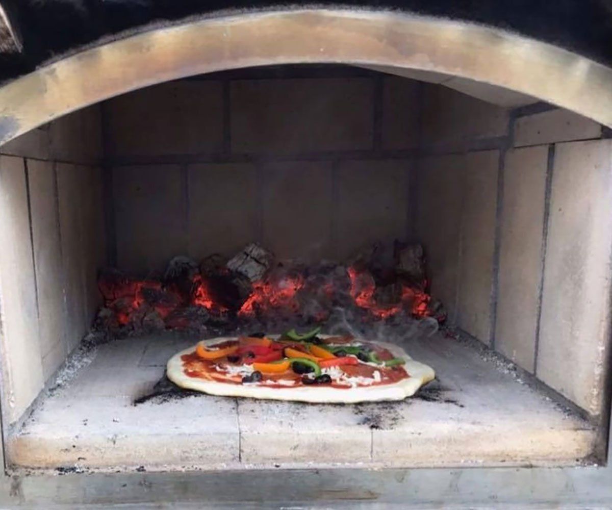 Round Grove outdoor fireplace and pizza in brick oven in Ohio backyard