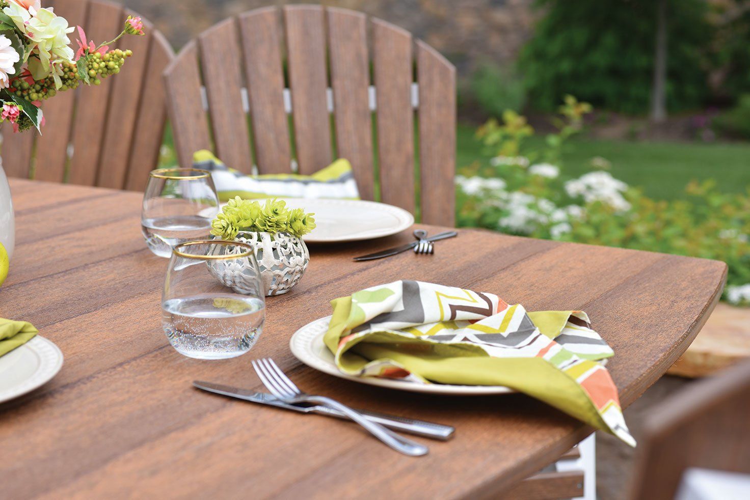 Outdoor dining table setting made from weather resistant ohio amish poly lumber with natural wood finish