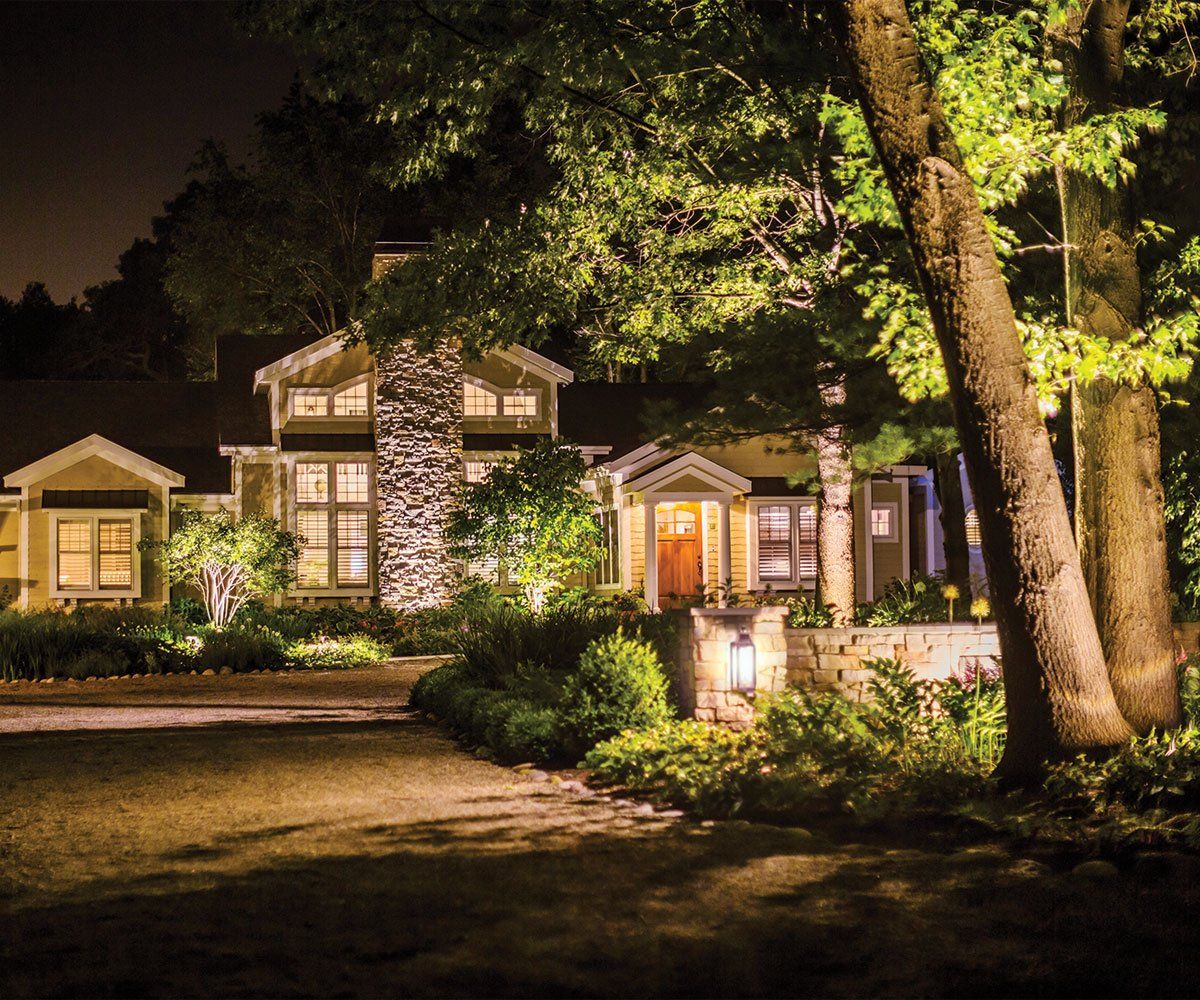 outdoor landscape lighting on trees and front door of ohio home