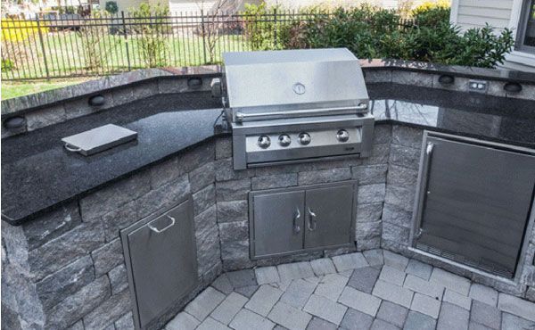 Outdoor kitchen with natural stone granite countertops in steel gray