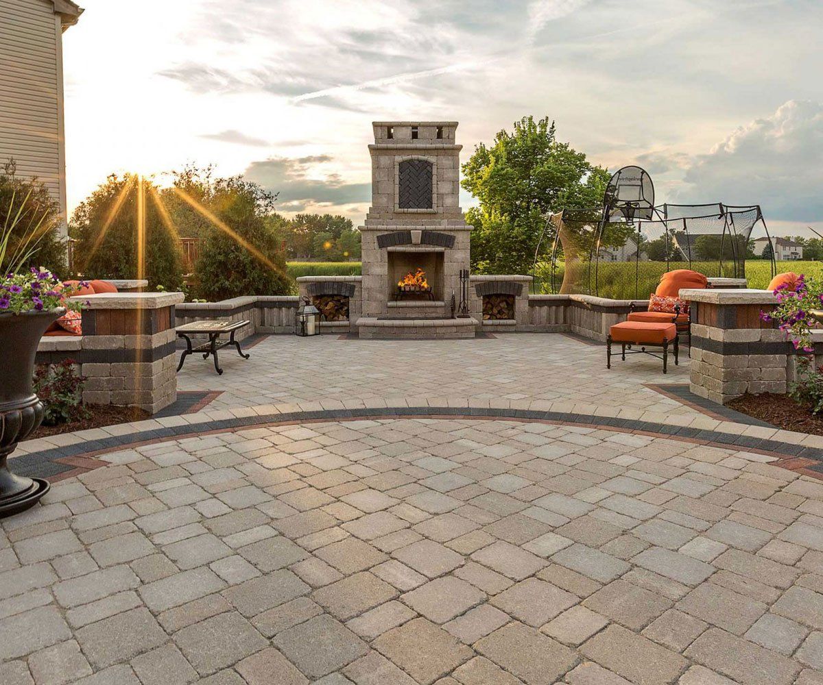 Paved patio with outdoor fireplace in Ohio backyard