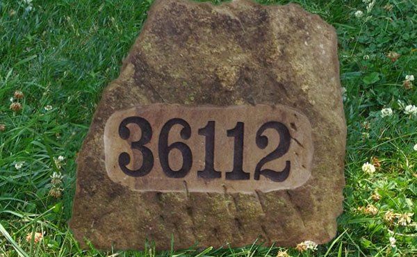 Engraved stone boulder with address