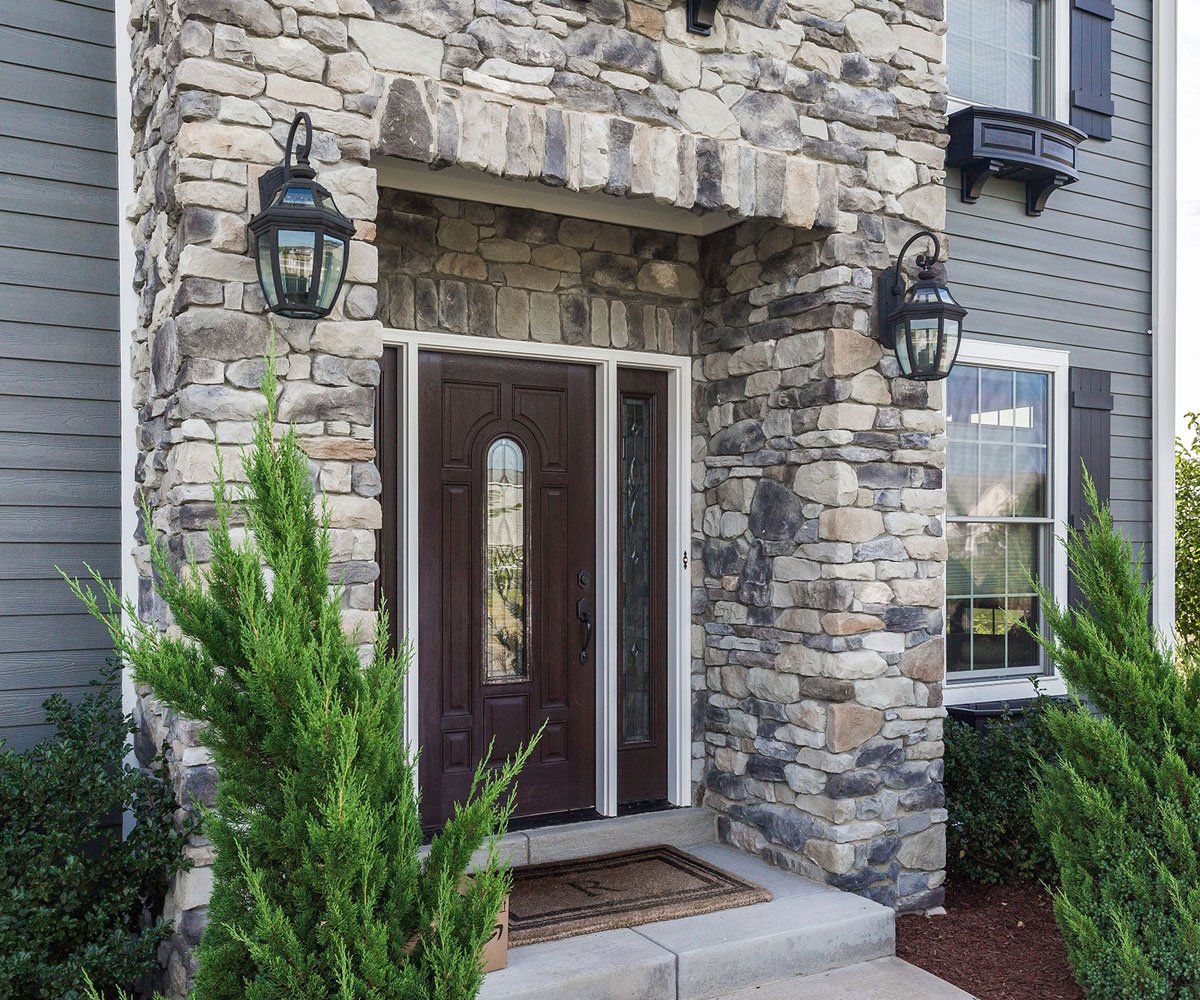 Chagrin Falls, Ohio home with exterior entryway limestone faux stone veneer siding