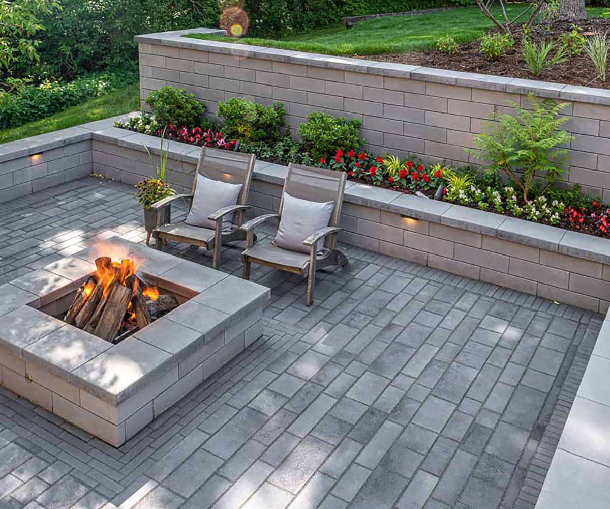 Outdoor fire pit and Ohio garden retaining wall made with Unilock pavers