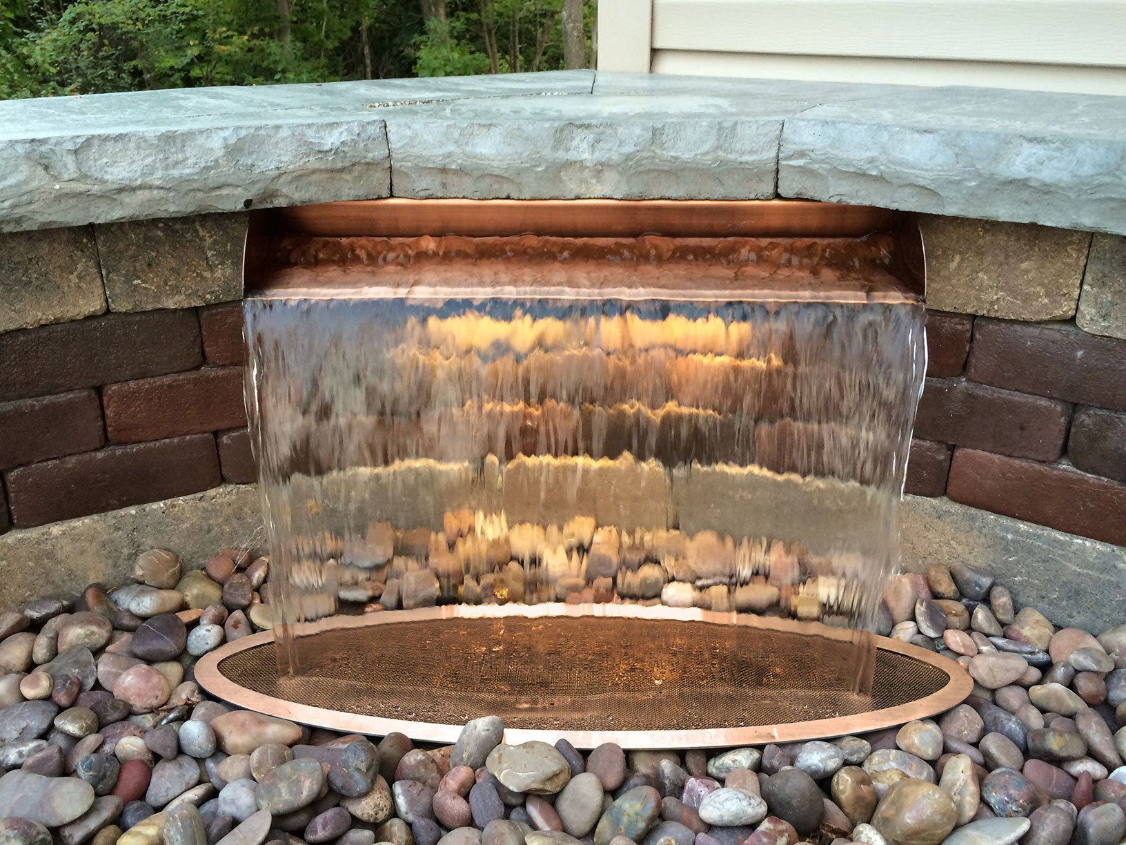 Outdoor shear curtain waterfall scupper for Huron landscape backyard patio