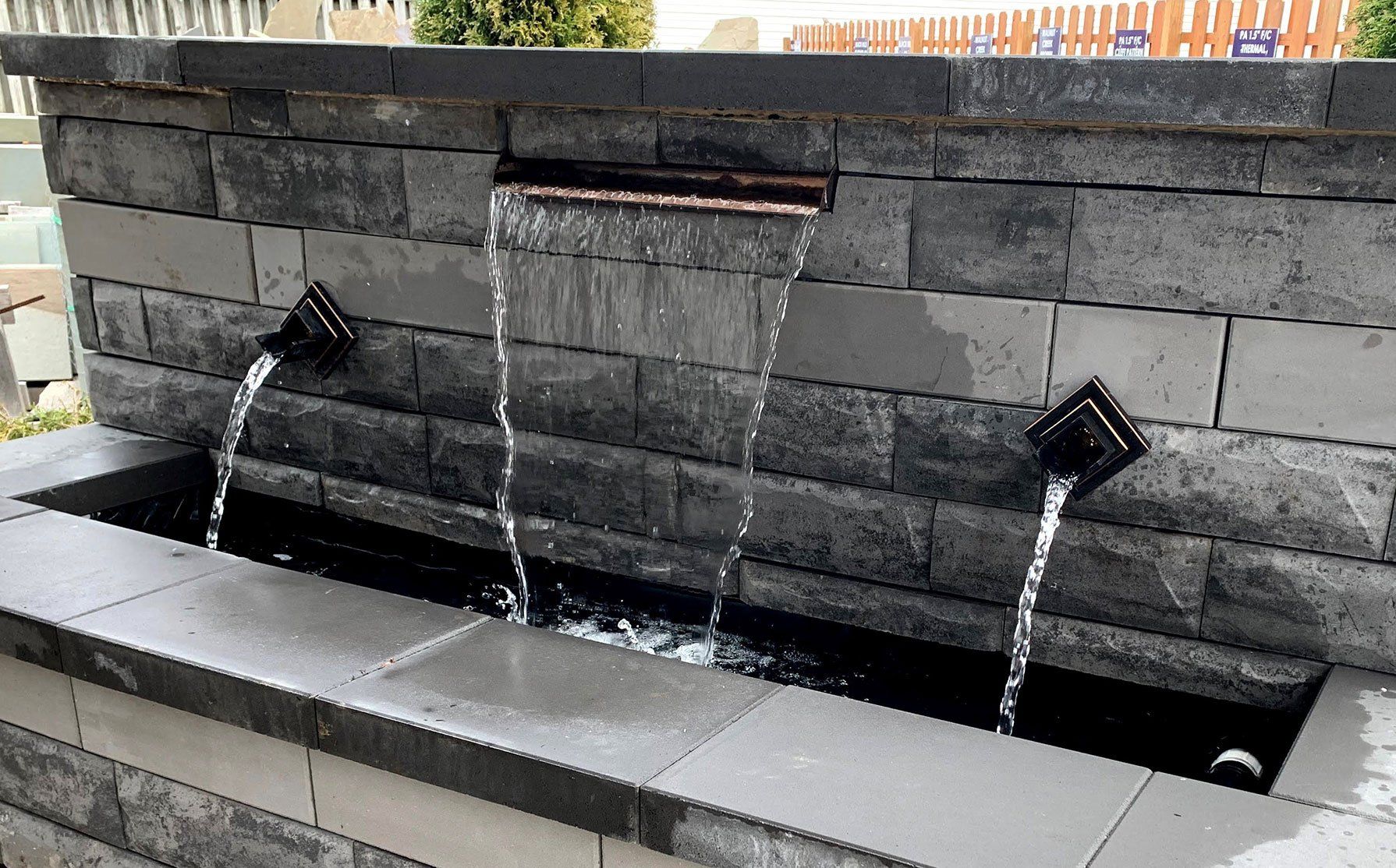 Water spouts and shear waterfall curtain in Unilock wall block