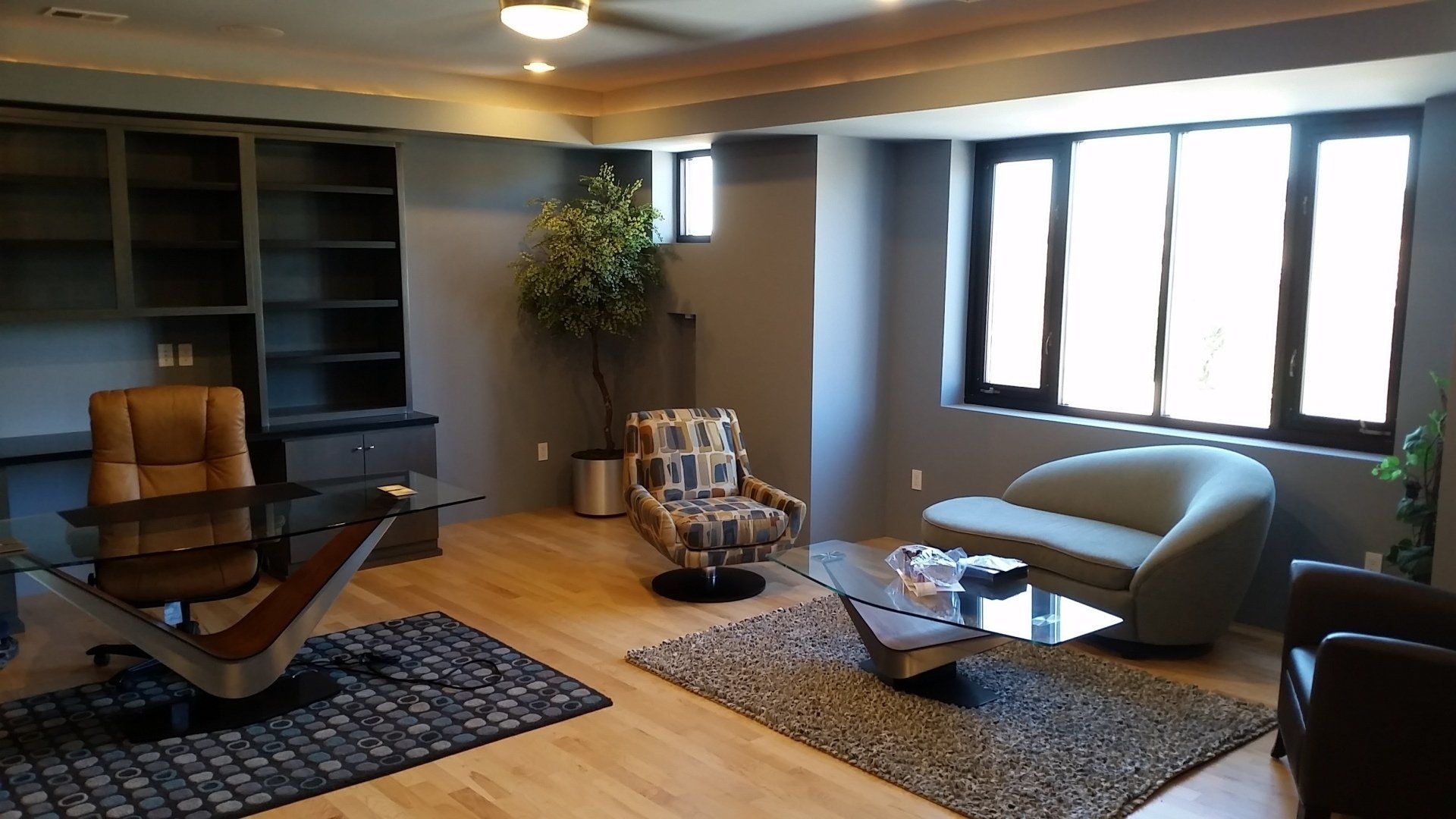 A living room with a table and chairs and a window
