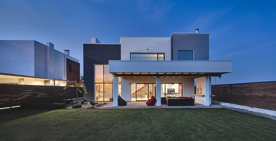 A modern house with a large lawn in front of it