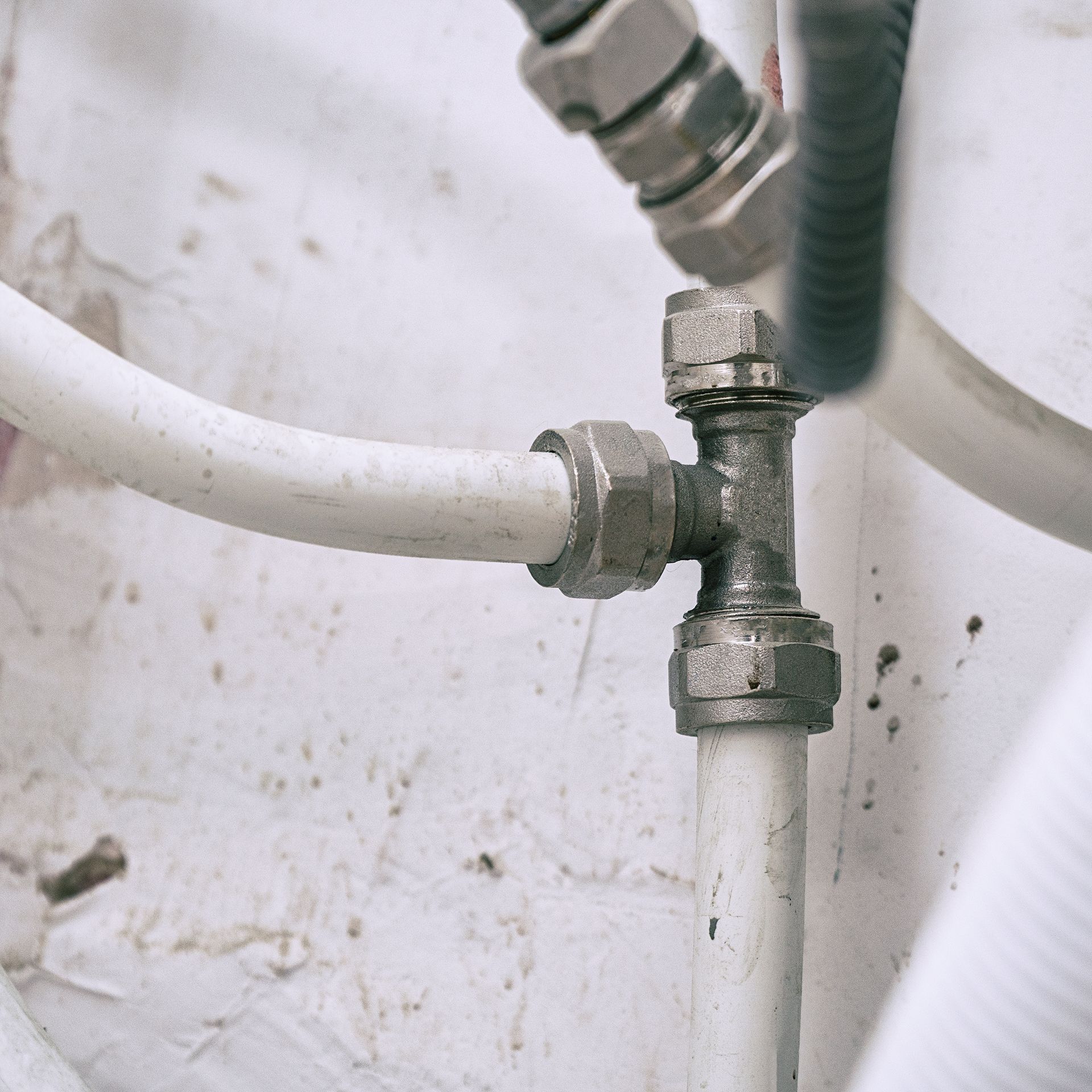 A close up of a pipe with a hose attached to it