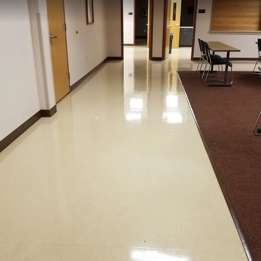 A hallway with a table and chairs in it