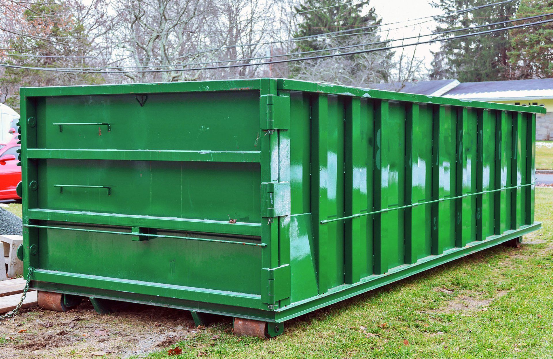 Green Dumpster on Driveway