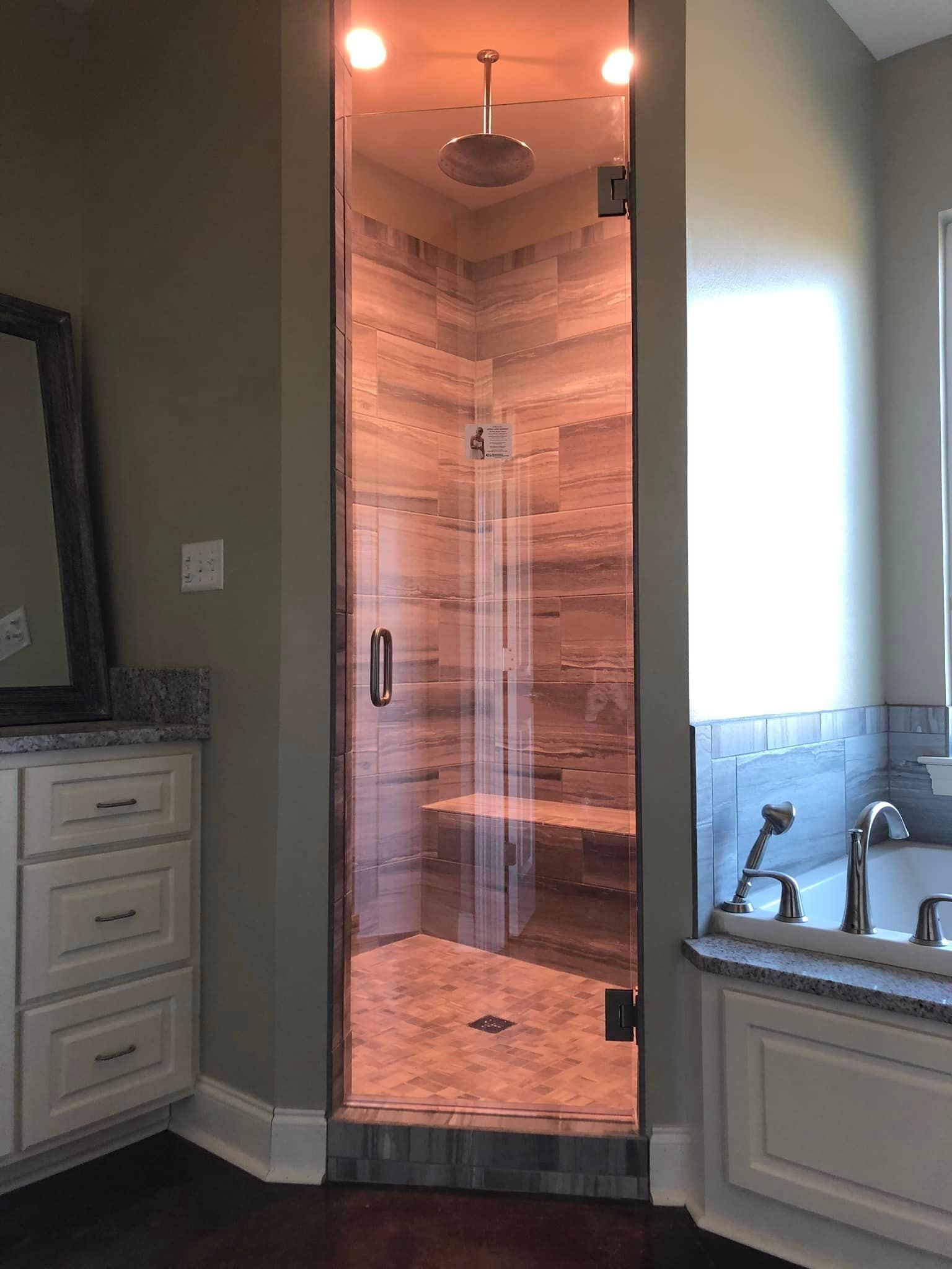 A bathroom with a walk in shower and a bathtub