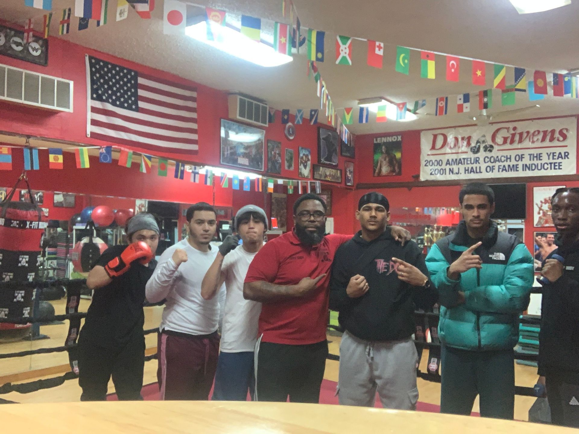 A group of young men are posing for a picture in a boxing ring