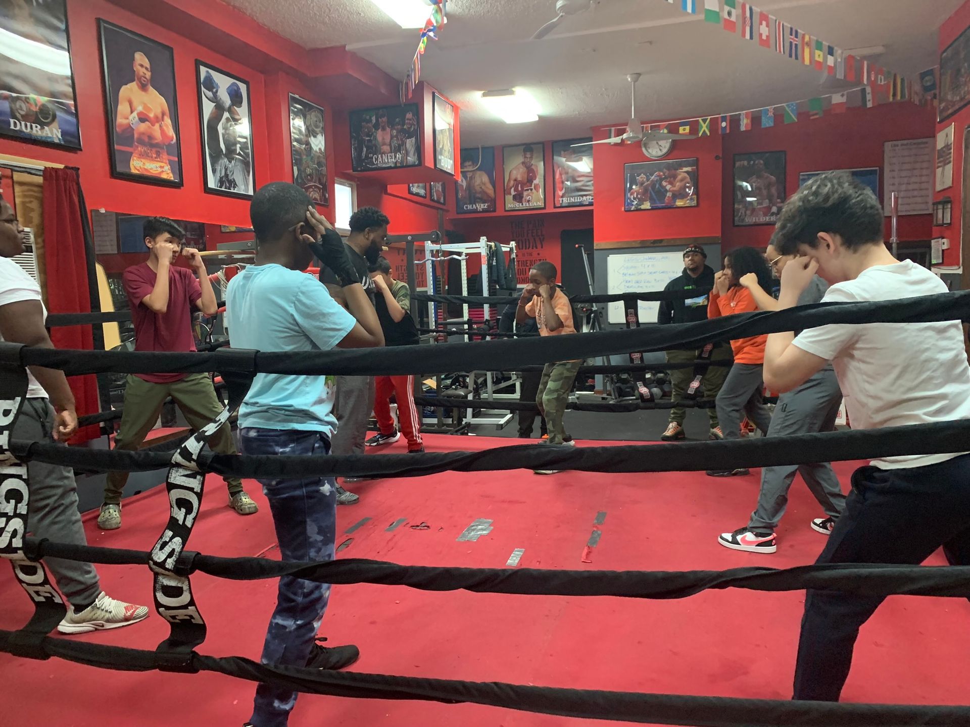 A group of people are practicing boxing in a gym.