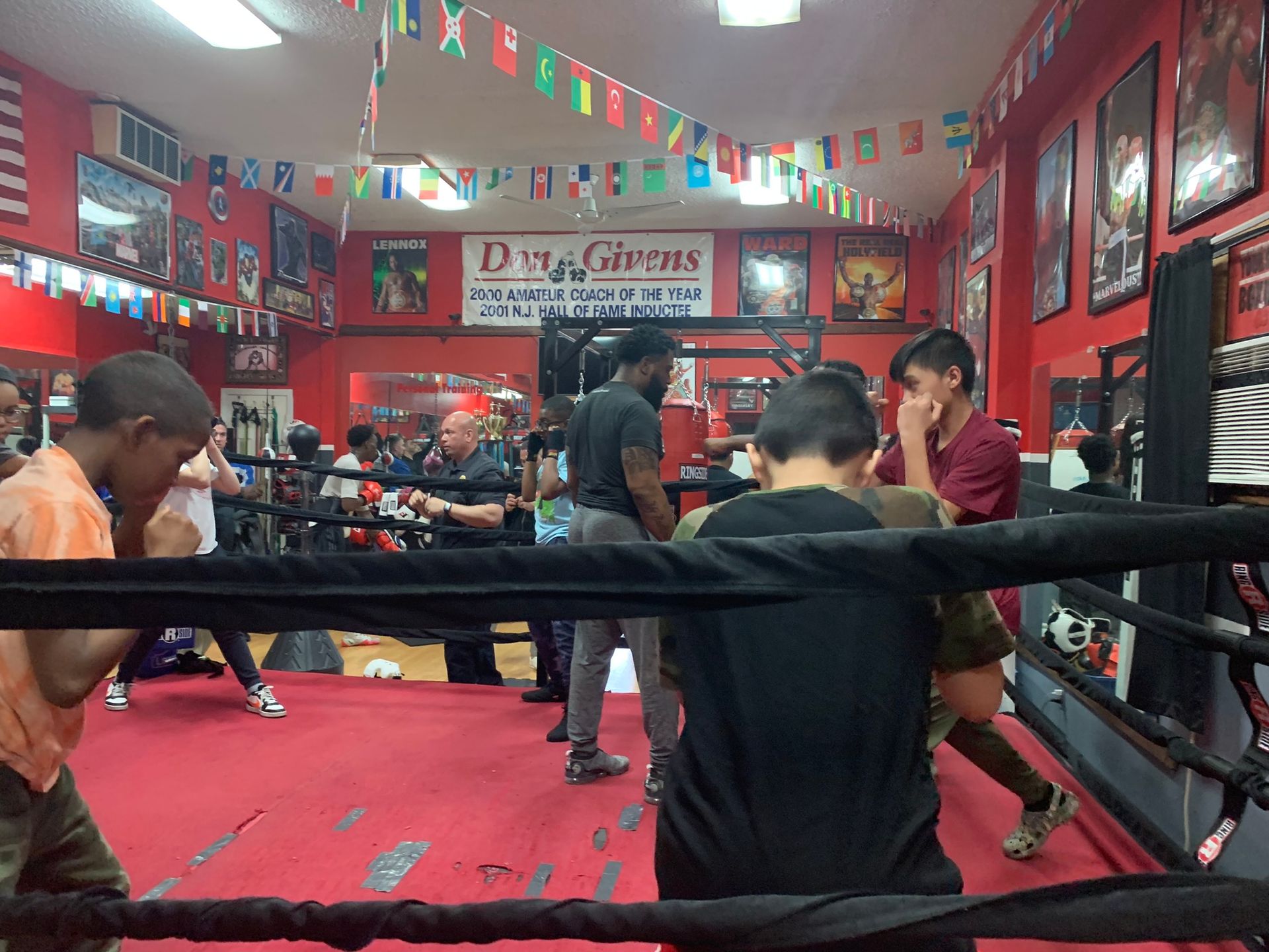 A group of people are in a boxing ring with a sign above them that says pirate 's
