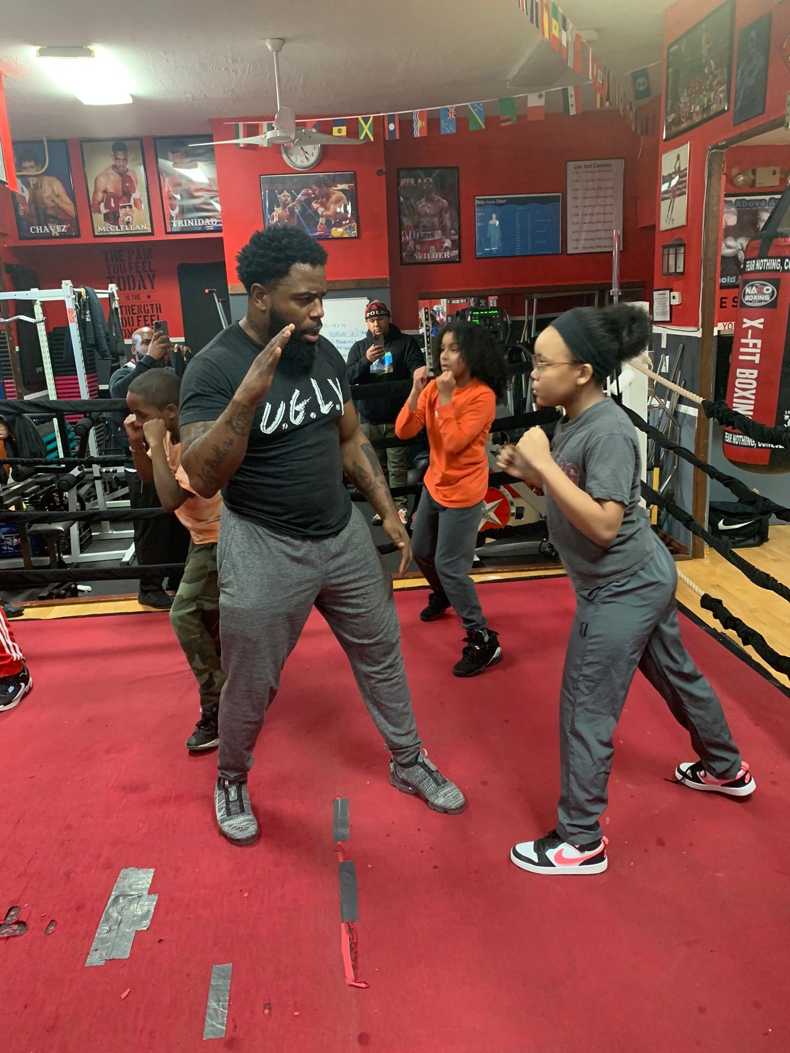A group of people are standing in a boxing ring.