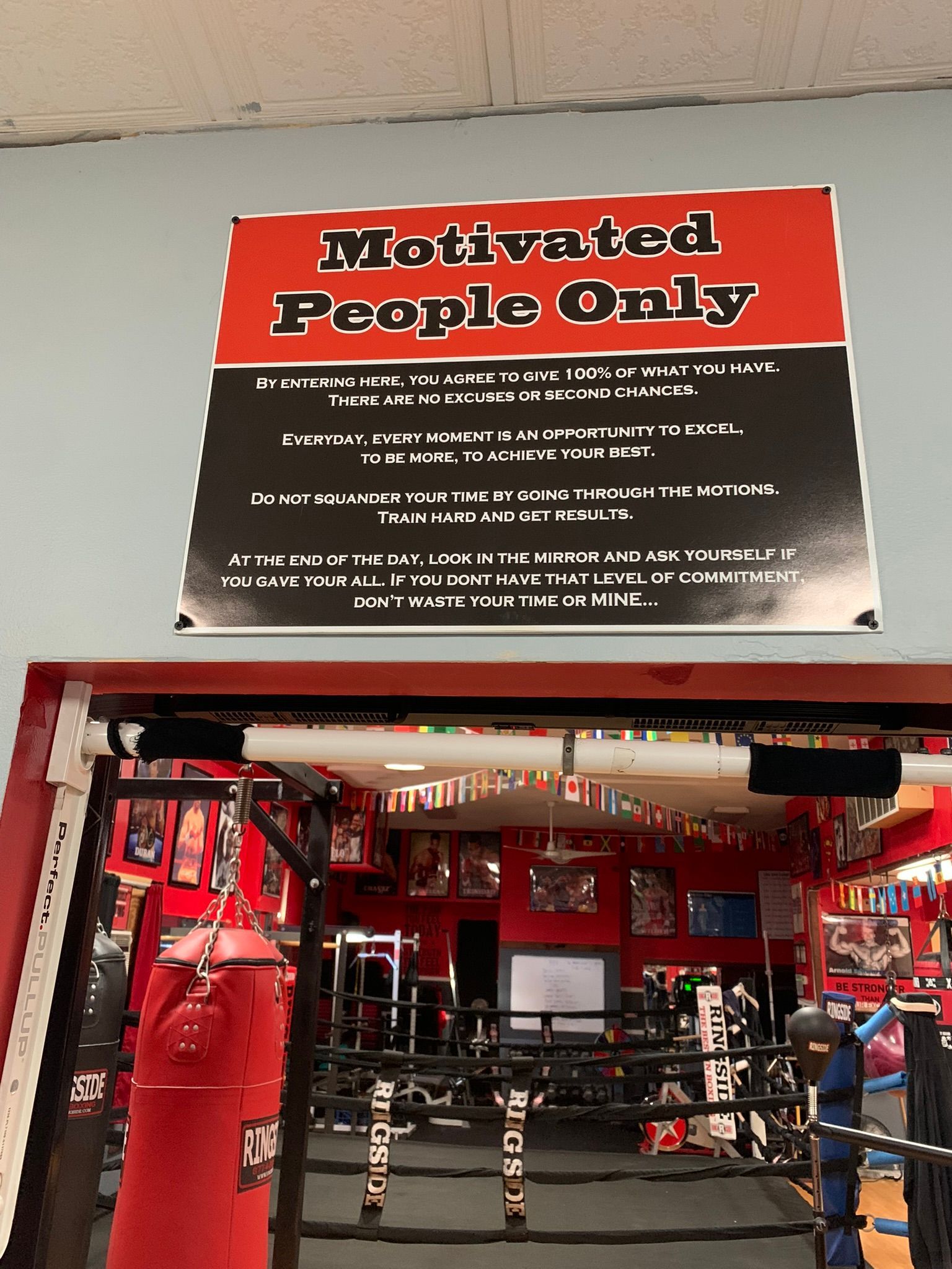 A gym with a sign that says motivated people only