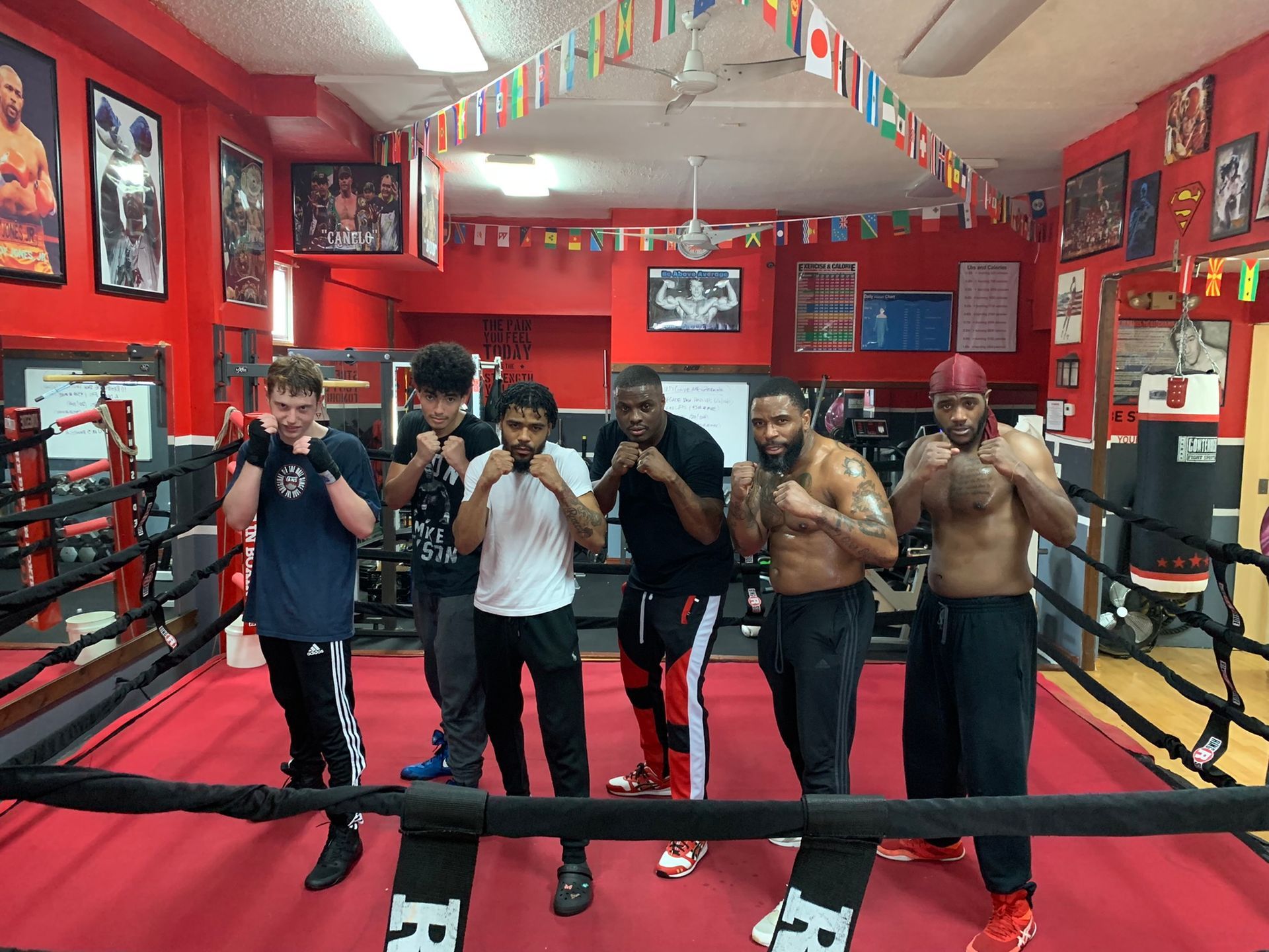 A group of men are standing in a boxing ring.