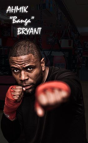 A man is standing in a boxing ring with his fist in the air.