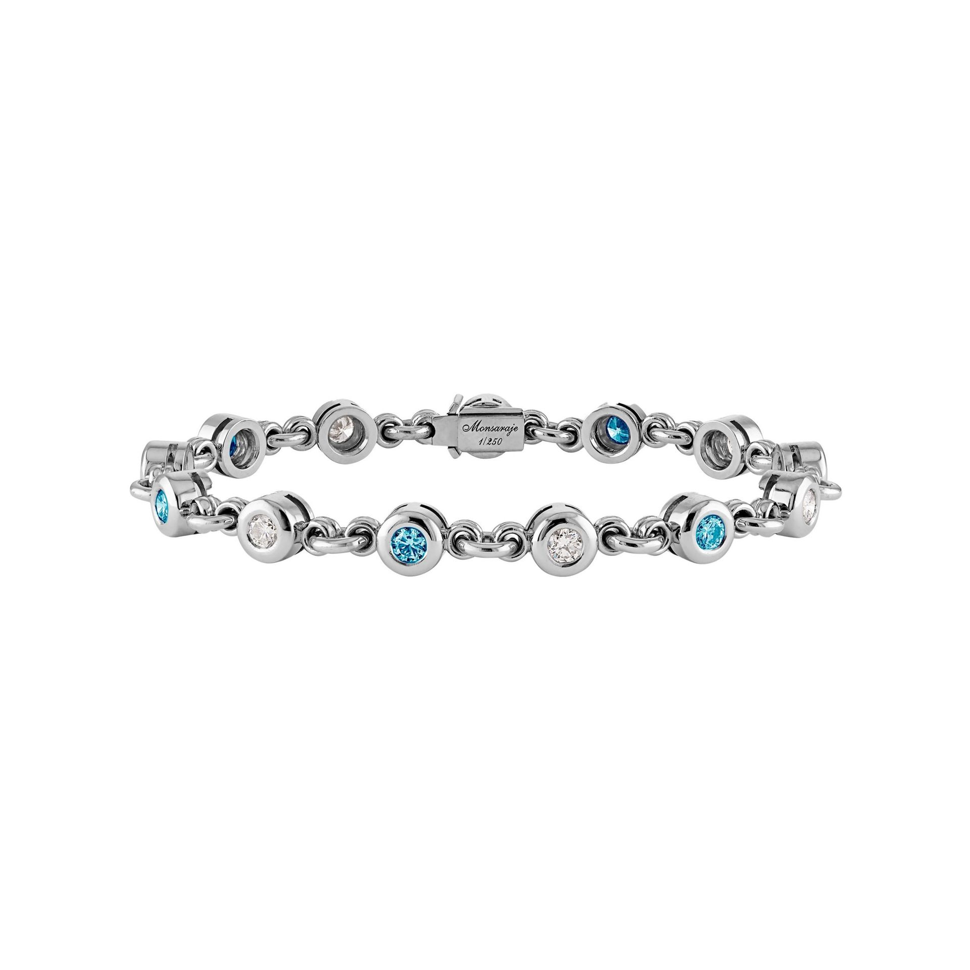 A silver bracelet with blue and white stones on a white background.
