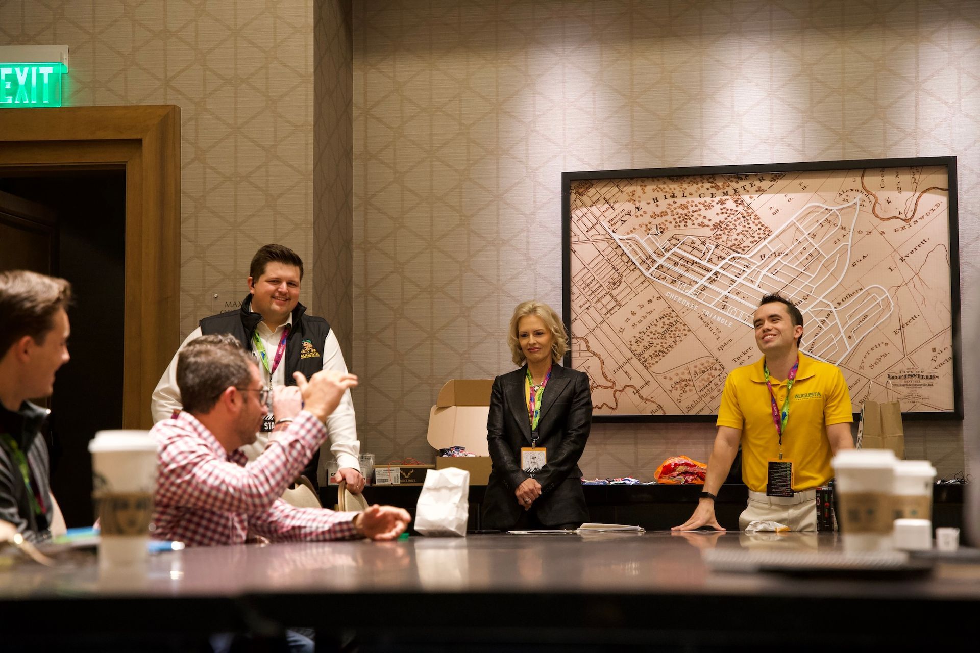 A group of people are sitting around a table in a conference room.