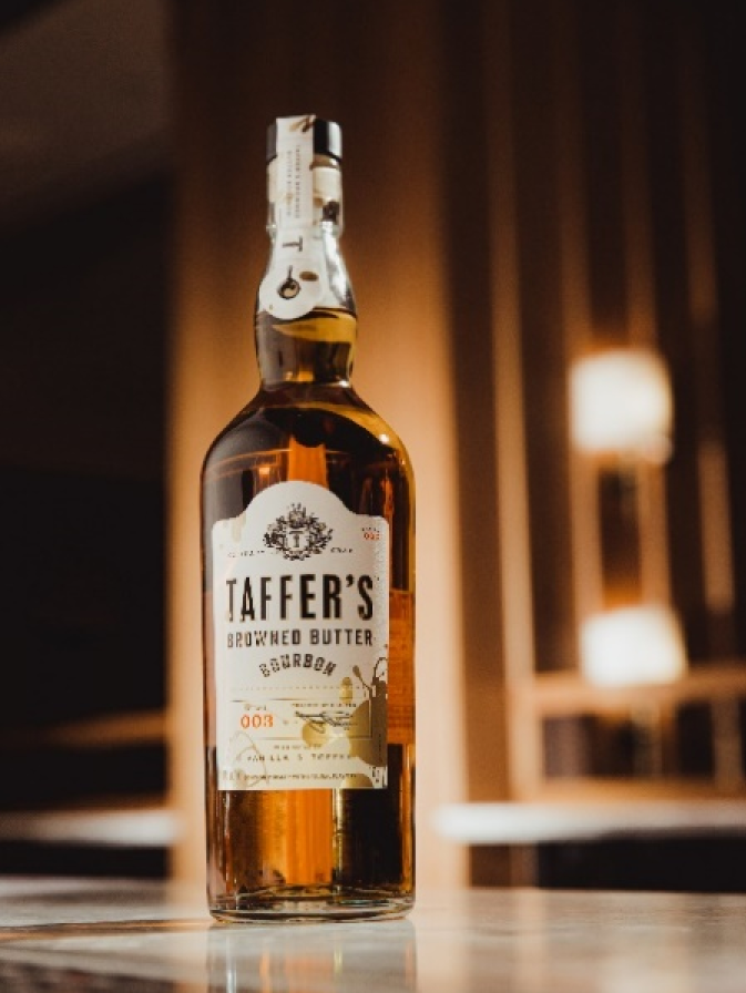 A bottle of taffer 's whiskey is sitting on a table