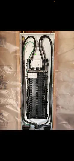 Electrical panel in wooden packaging. Black wires and breakers.