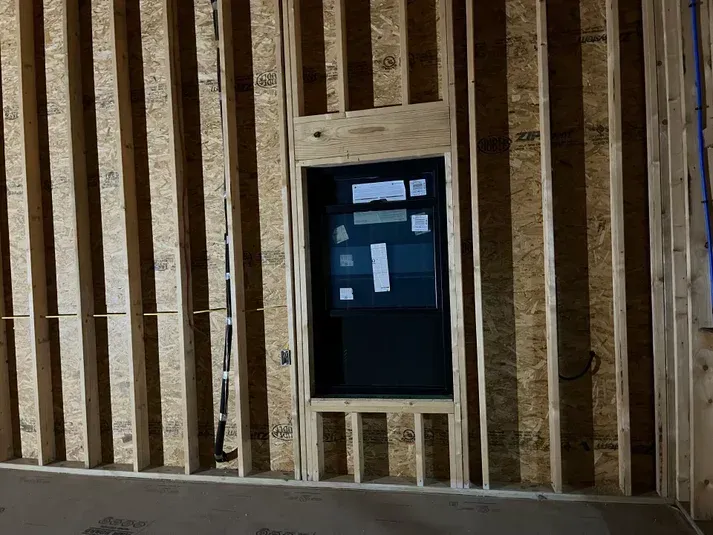 Interior wall framing with a recessed electrical panel.