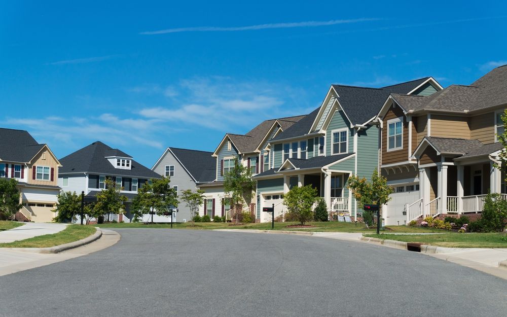 A Row of Houses on a Residential Street With a Blue Sky in the Background — Key2 Conveyancing In Mid North Coast, NSW