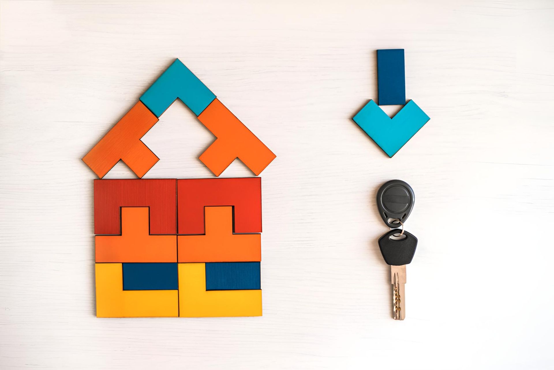 A House Made of Wooden Blocks Next to a Car Key — Key2 Conveyancing In Forster, NSW