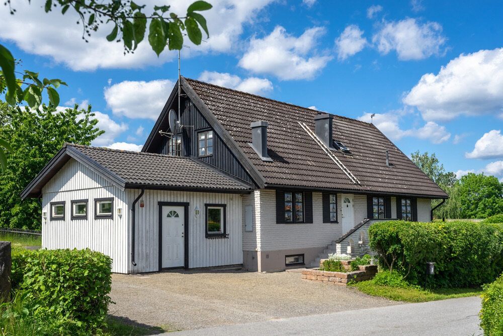 A White House With a Brown Roof and a Garage — Key2 Conveyancing In Forster, NSW