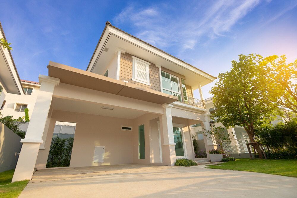 A large house with a garage and a driveway in front of it — Key2 Conveyancing In Old Bar, NSW