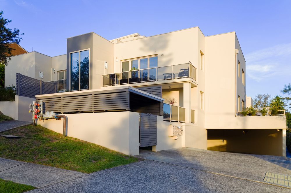 A Large White House is Sitting on Top of a Hill — Key2 Conveyancing In Hallidays Point, NSW