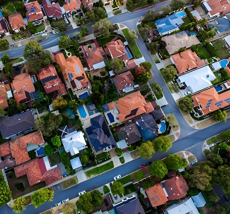 An Aerial View of a Residential Area With Lots of Houses and Trees — Key2 Conveyancing In Forster, NSW