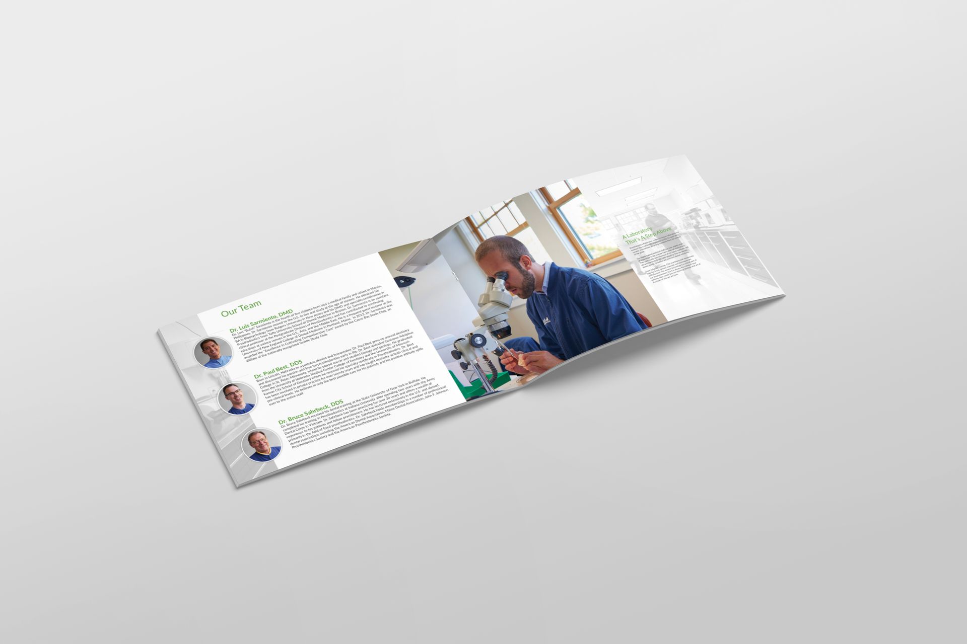 Brochure open on a white surface, featuring a man using a microscope and text with profile photos.
