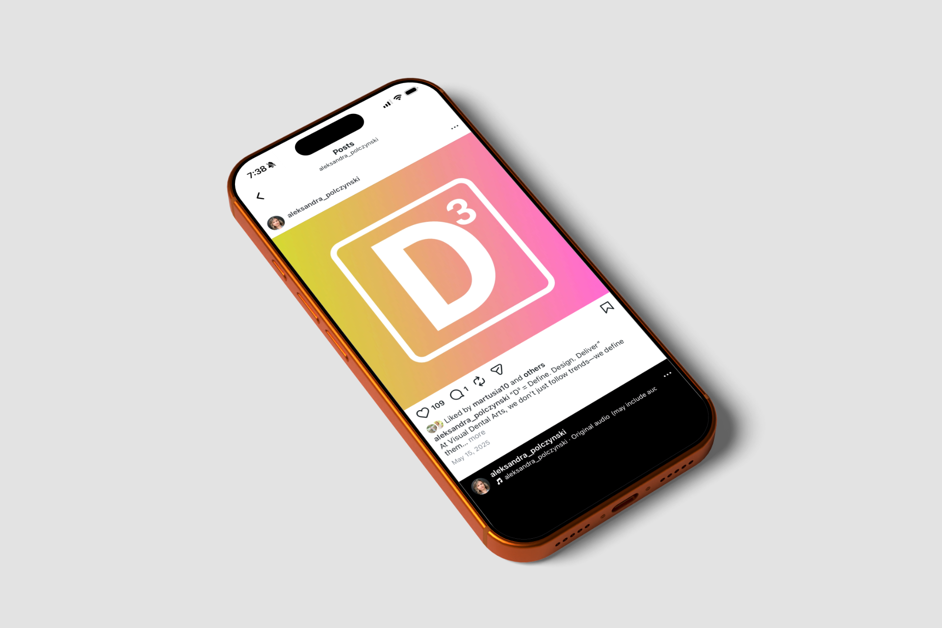 Smartphone showing D³ logo within a social media post; pink, yellow gradient; phone on white surface.