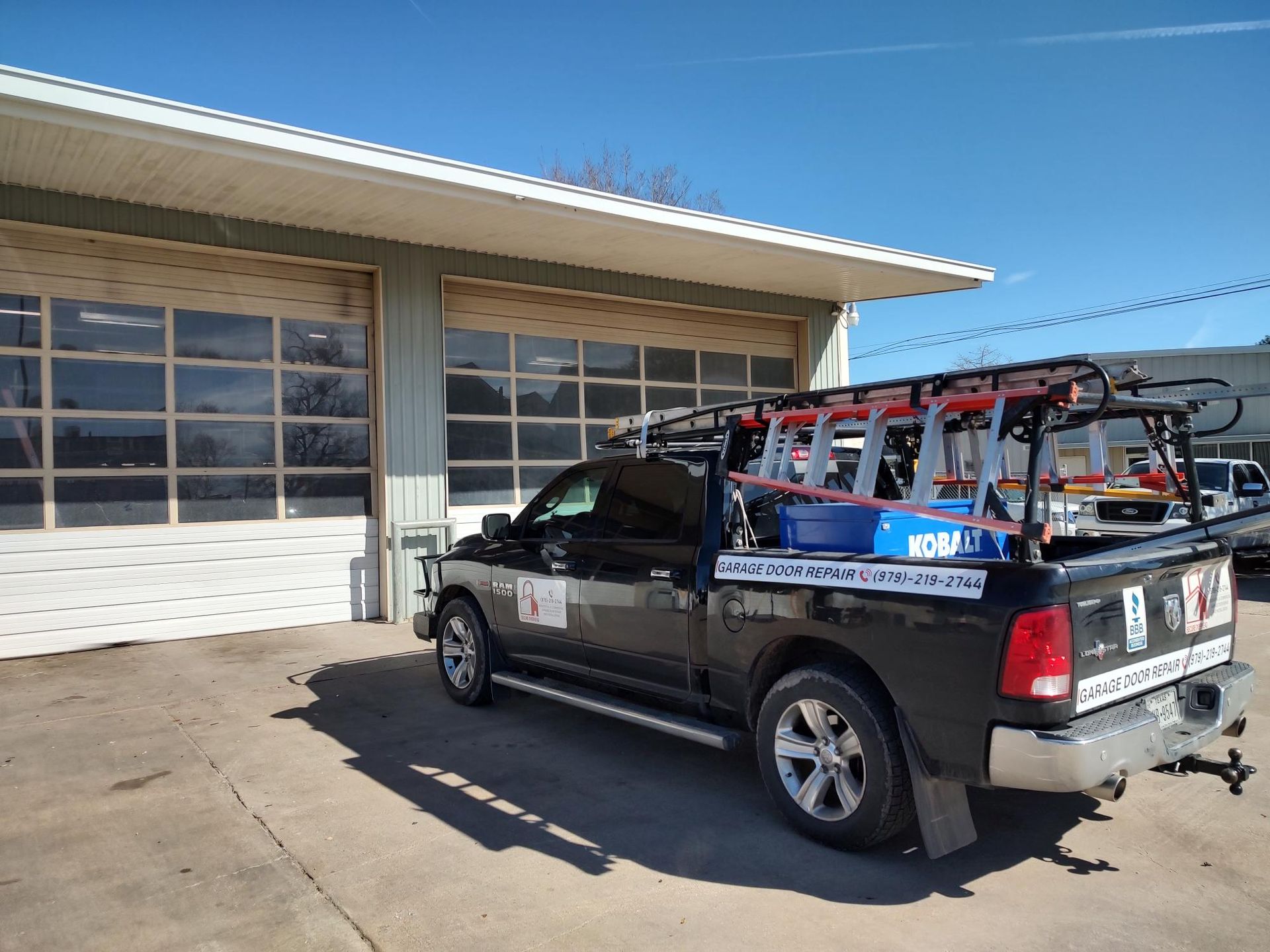 Man Repairing Garage Door — Bryan, TX — Secure Overhead Doors