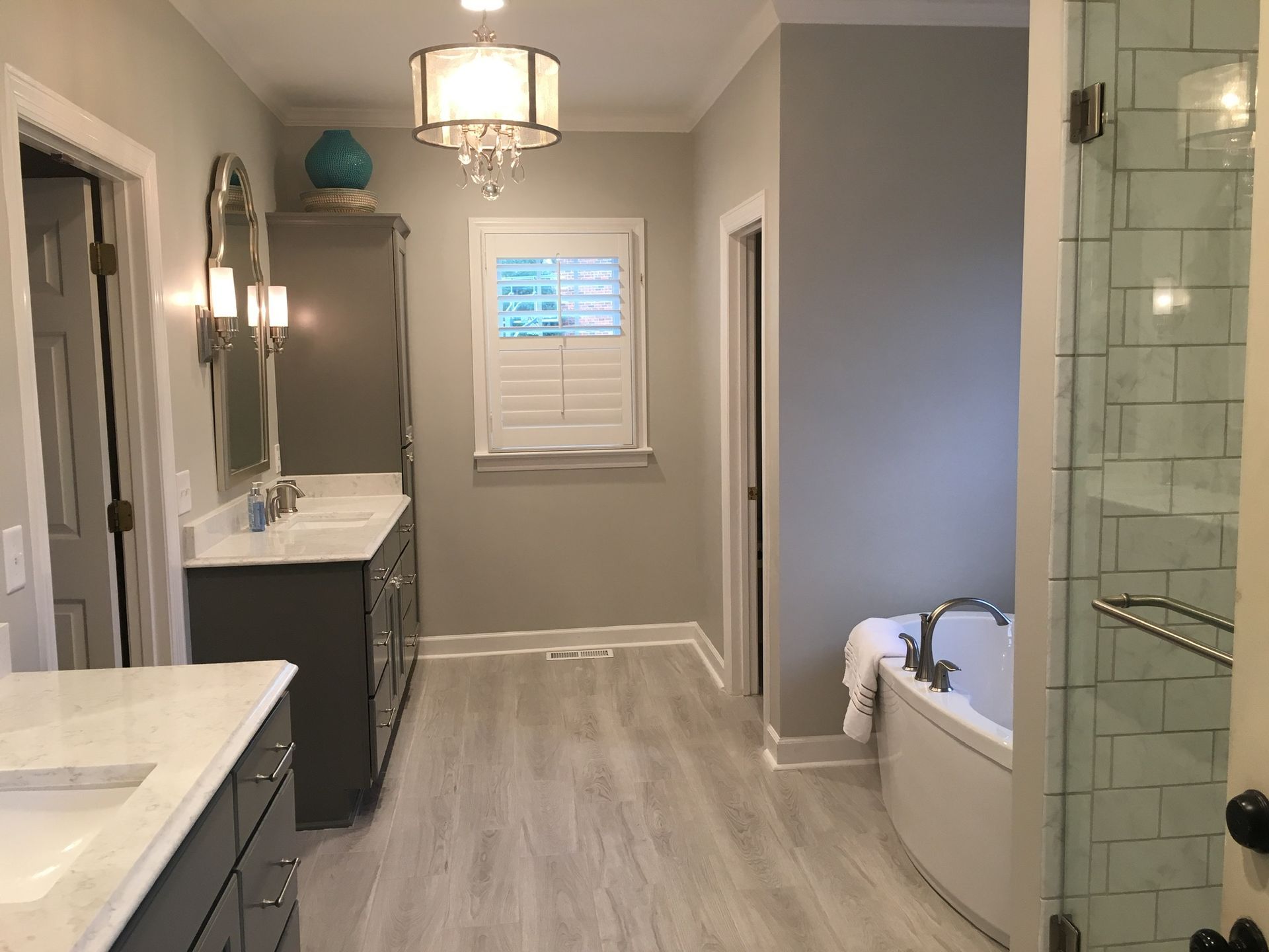 a bathroom with two sinks , a tub and a shower