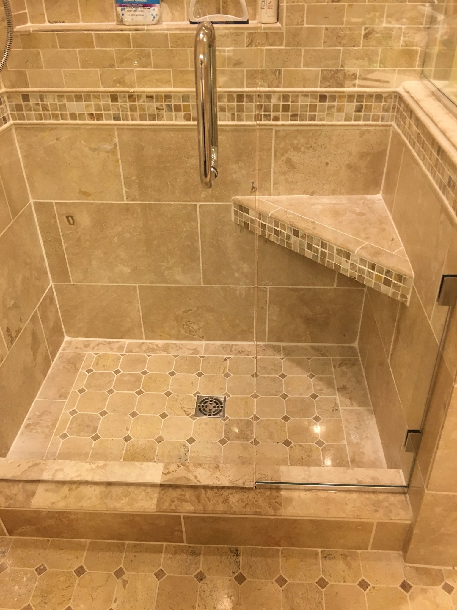 a bathroom with a walk-in shower with a glass door