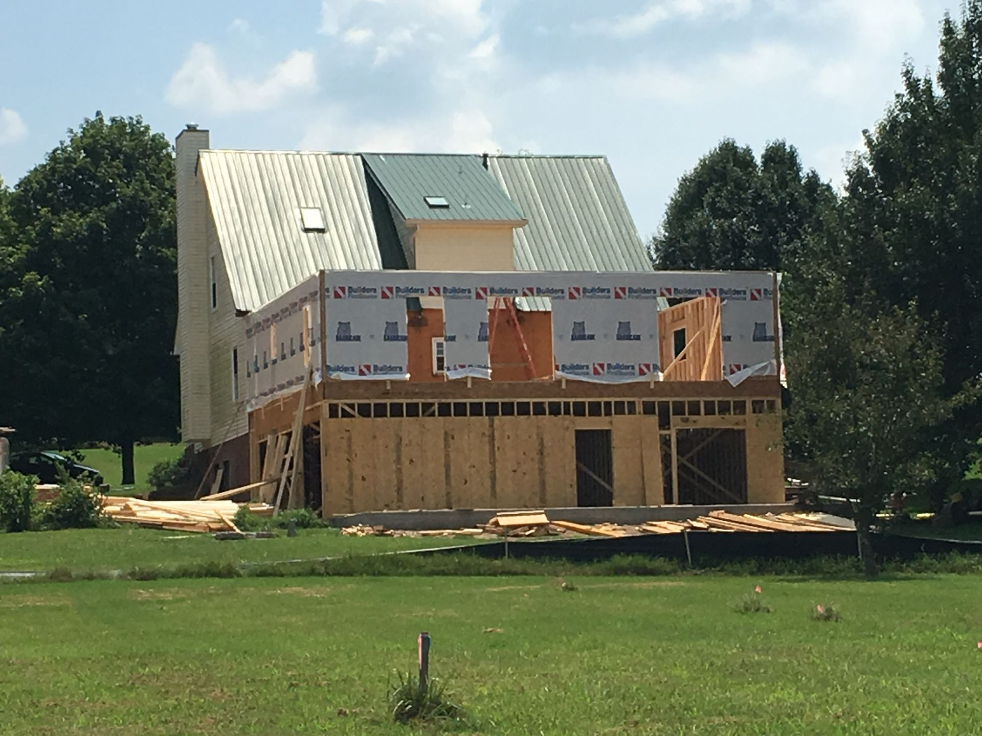 a house that is being built with a green roof