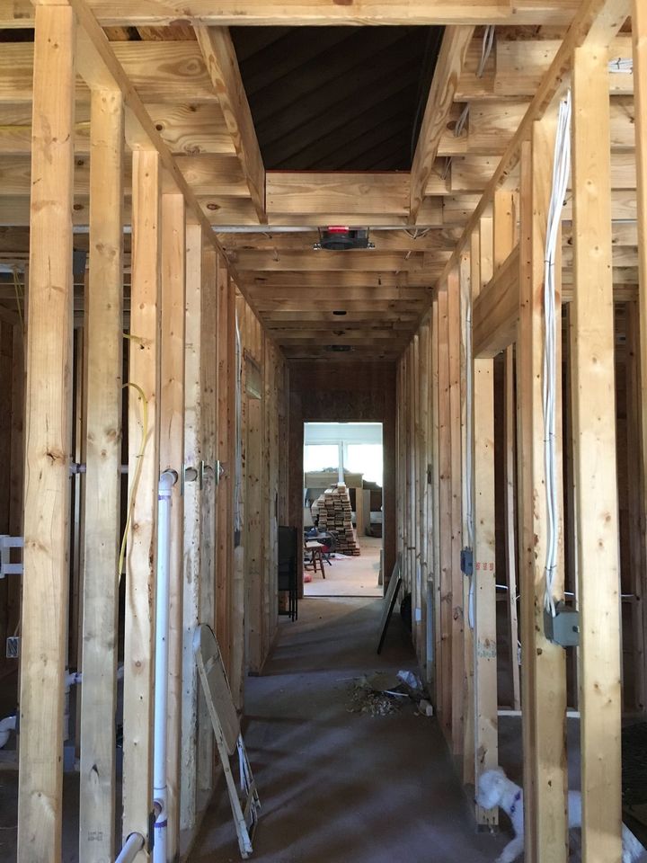 a long wooden hallway in a house under construction