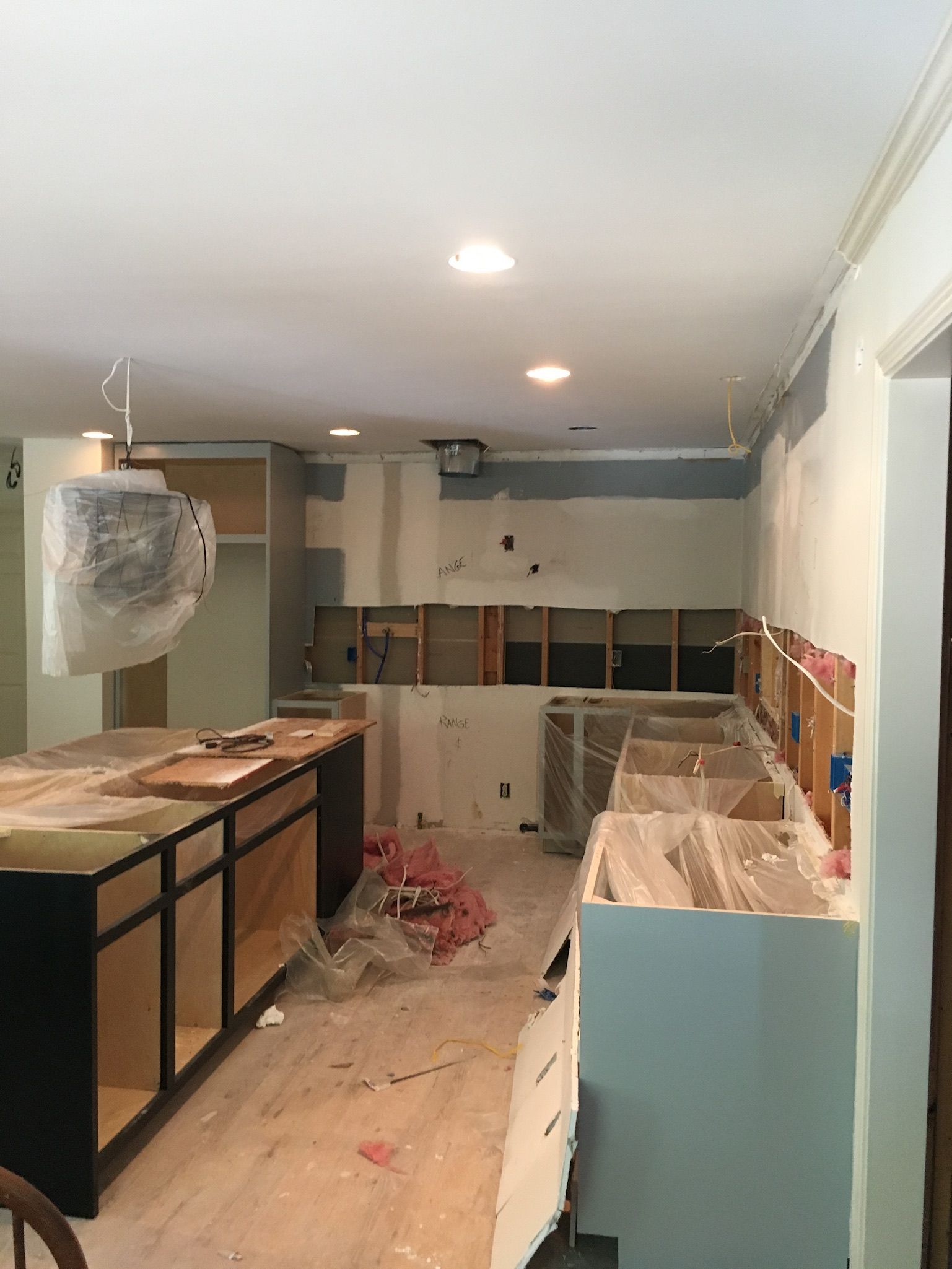a kitchen under construction with a lot of cabinets and counters
