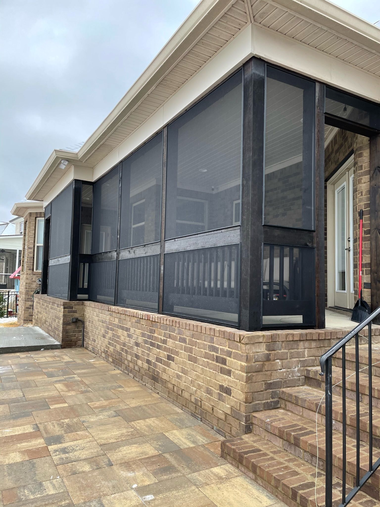 a house with a screened in porch and stairs leading up to it