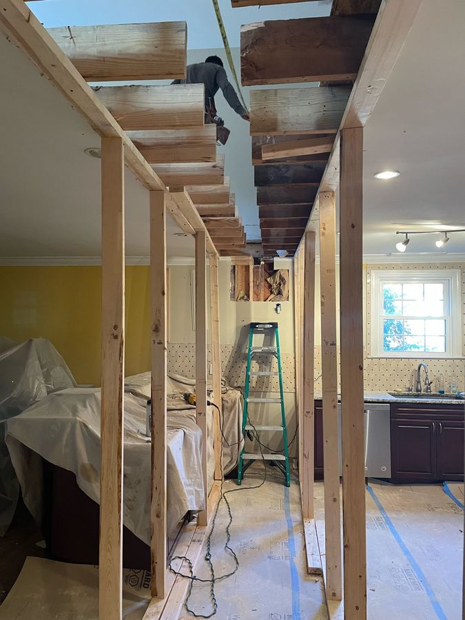a ladder is hanging from the ceiling of a house under construction
