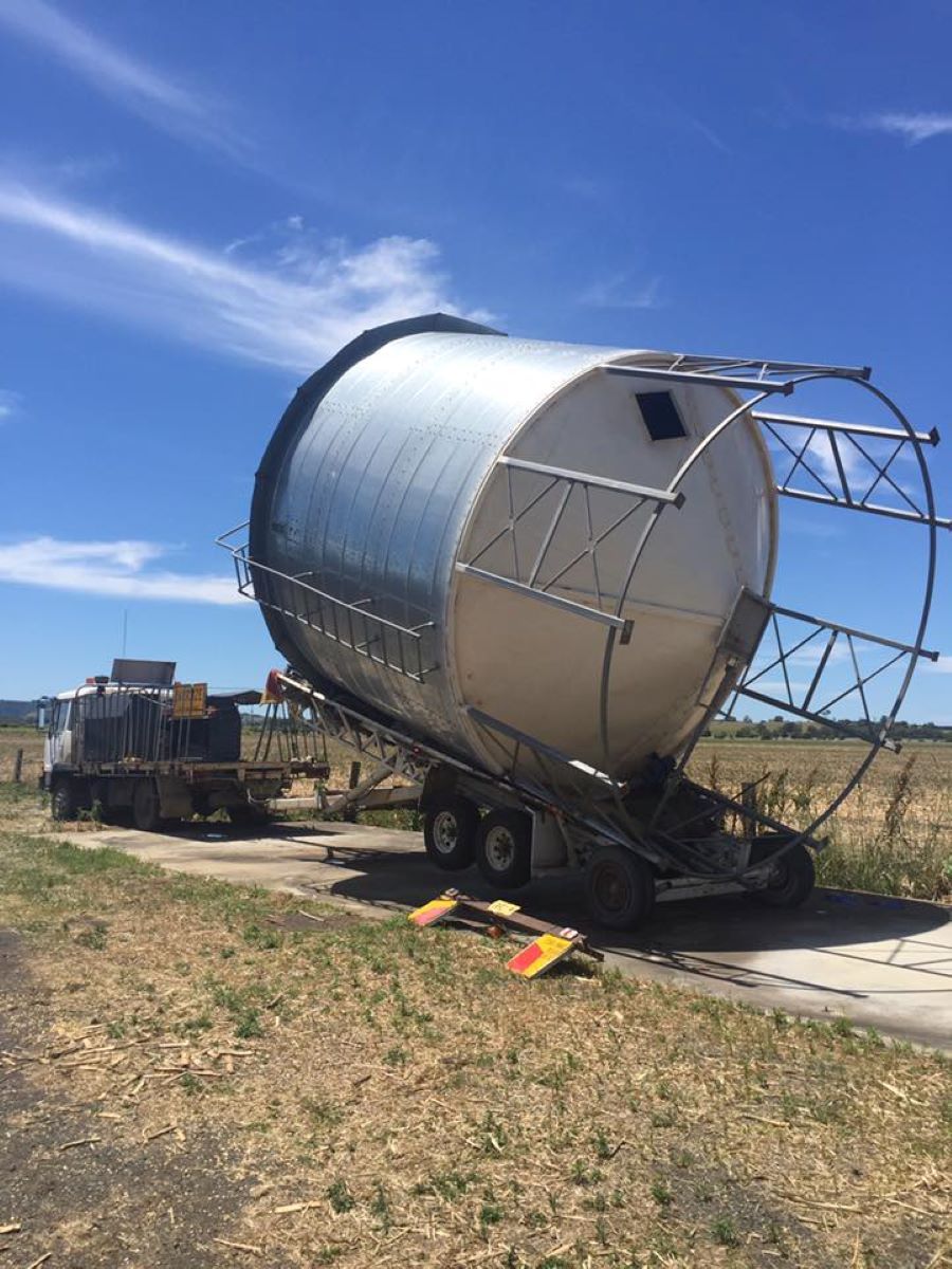 A Large Tank is Being Loaded on a Trailer — Wallamore Grading & Packaging In Armidale, NSW