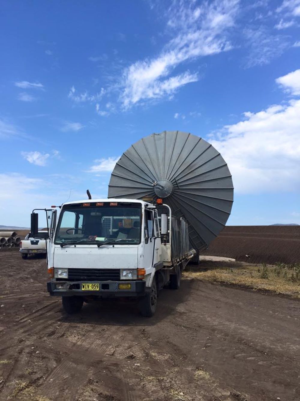 A White Truck With a Metal Structure Shaped like an umbrella on the back of it— Wallamore Grading & Packaging In Barraba, NSW