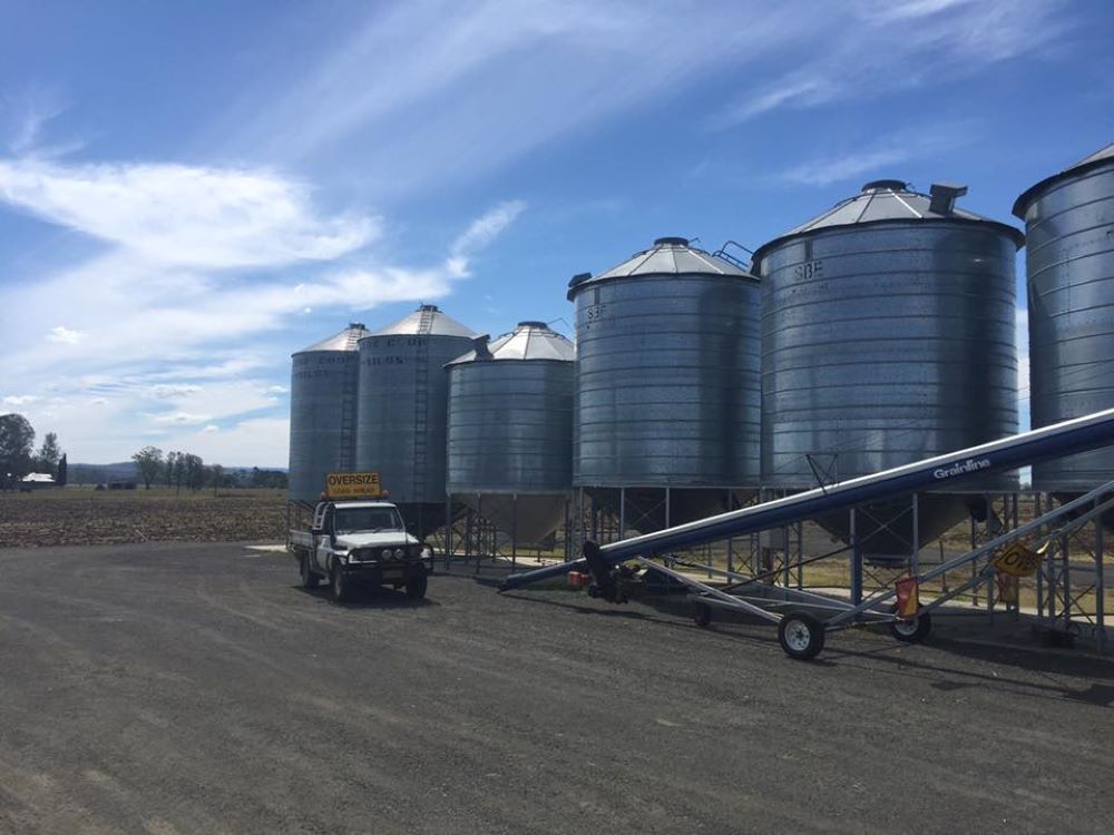 A Truck is Parked in Front of a Row of Silos — Wallamore Grading & Packaging In Gunnedah, NSW