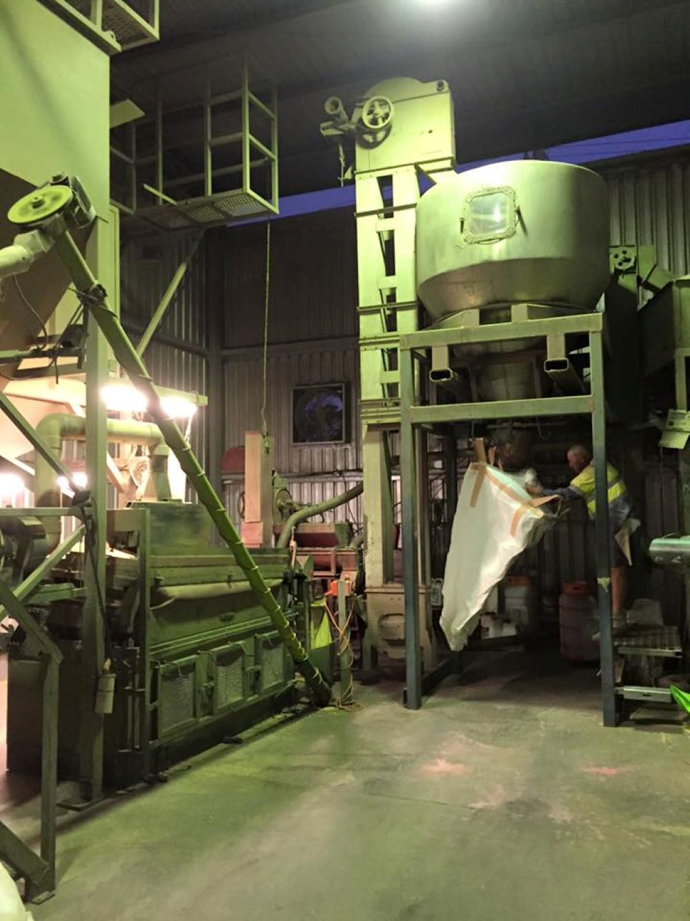 A Man is Standing in Front of a Machine in a Factory — Wallamore Grading & Packaging In Wallamore, NSW
