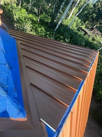 A large mirror is being worked on in a room