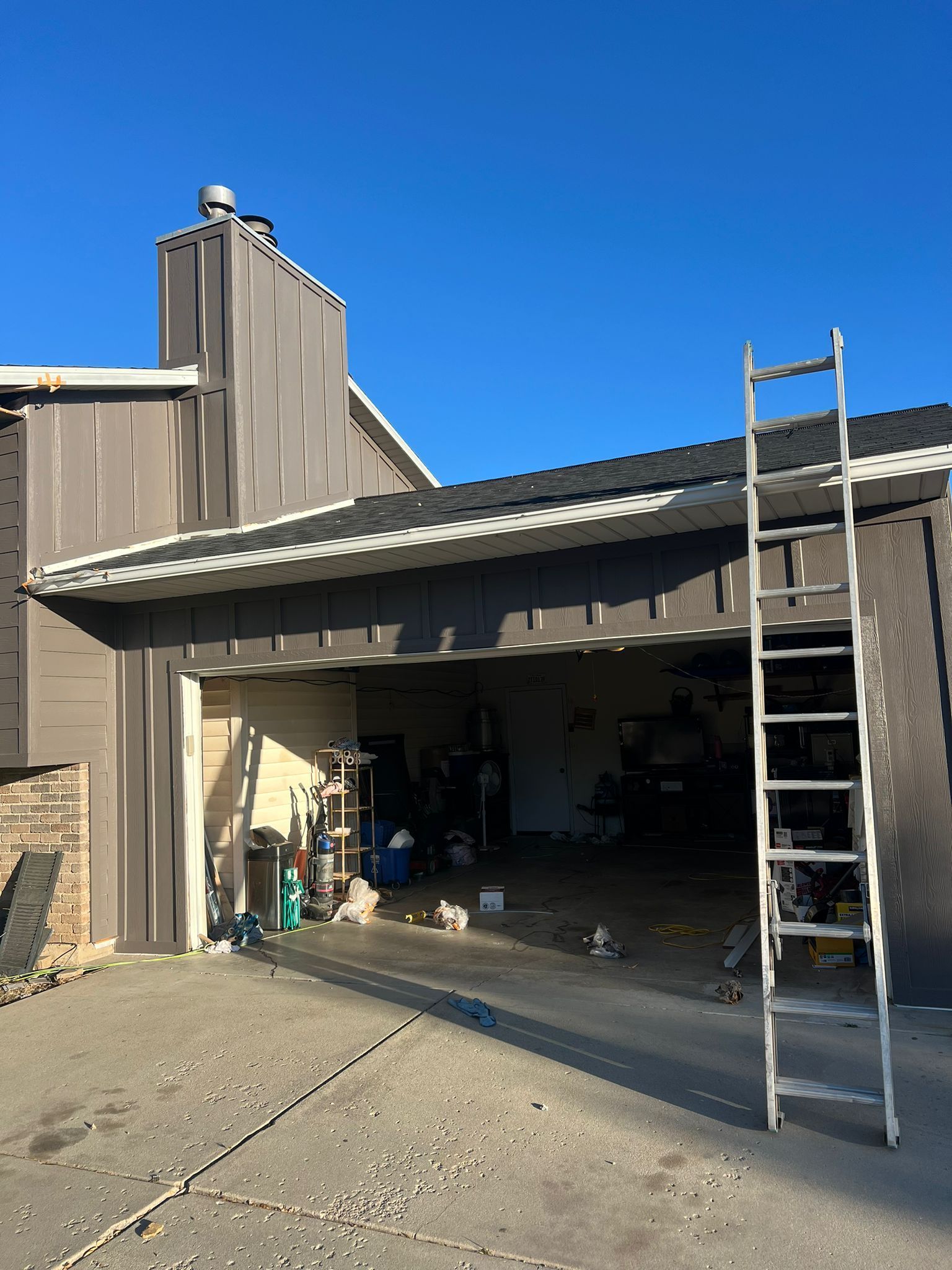 A close up of a green and silver machine in a factory.